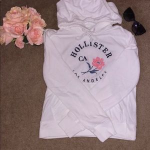 Hollister: White hoodie with floral design.